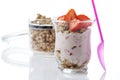 Glass with yogurt, granola and strawberries, plastic spoon