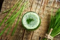 A glass of young barley grass juice with freshly grown barley grass Royalty Free Stock Photo