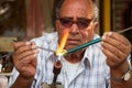 The glassblower works on the street. Royalty Free Stock Photo