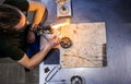 Glassblowing Young Man Working on a Torch Flame with Glass Tubes