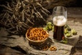 Glasse beer with wheat and hops, basket of pretzels Royalty Free Stock Photo