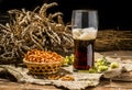 Glasse beer with wheat and hops, basket of pretzels Royalty Free Stock Photo