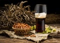 Glasse beer with wheat and hops, basket of pretzels Royalty Free Stock Photo