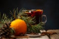 Glasses with aromatic hot mulled wine with original festive christmas composition on rustic wooden table. Tasty winter alcoholic