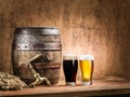 Glasses of beer and ale barrel on the wooden table. Royalty Free Stock Photo