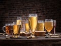 Glasses of beer and snacks on the wooden table.