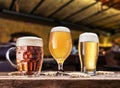 Glasses of beer on the wooden table. Blurred pub interior at the background. Assortment of beer Royalty Free Stock Photo