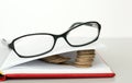 Glasses, book and coins Royalty Free Stock Photo