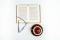 Glasses, a book and a cup of tea on a white background Royalty Free Stock Photo
