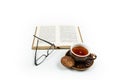 Glasses, a book and a cup of tea on a white background Royalty Free Stock Photo