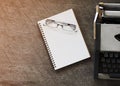 Glasses with book notes and old typing machine vintage Royalty Free Stock Photo
