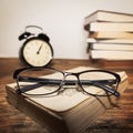 Glasses on the books and clock Royalty Free Stock Photo