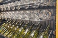 Glasses and bottles on a rack in the wine cellar Royalty Free Stock Photo