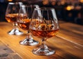 Glasses of brandy cognac alcoholic drink on wooden table.Macro.AI Generative