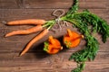 Glasses of carrot juice and fresh carrots on old wooden background, top view Royalty Free Stock Photo