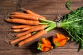 Glasses of carrot juice and fresh carrots on old wooden background, top view Royalty Free Stock Photo