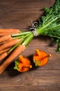 Glasses of carrot juice and fresh carrots on old wooden background Royalty Free Stock Photo