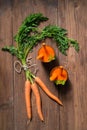 Glasses of carrot juice and fresh carrots on old wooden background Royalty Free Stock Photo