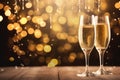 Glasses of champagne on bokeh background. New Year celebration, Champagne for festive cheers with gold sparkling bokeh background Royalty Free Stock Photo