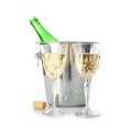 Glasses of champagne and bottle in ice bucket on white background Royalty Free Stock Photo