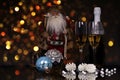Glasses champagne, bottle, Santa Claus and Christmas decoration Royalty Free Stock Photo