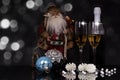Glasses champagne, bottle, Santa Claus and Christmas decoration Royalty Free Stock Photo