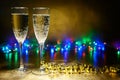 Glasses of champagne on a bright background with garlands Royalty Free Stock Photo