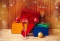 Glasses of champagne,  christmas balls and christmas presents on wooden table Royalty Free Stock Photo