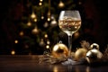 Glasses of champagne and christmas decorations on wooden table over blue bokeh background, Champagne Glass Adorned with Christmas Royalty Free Stock Photo