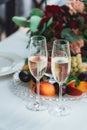 Glasses with champagne drink on a table. Happy newlyweds drinking. Loving couple created new family. Royalty Free Stock Photo