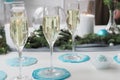 Glasses of champagne on the festive table decorated for the new year in delicate blue and white colors Royalty Free Stock Photo