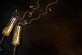 Glasses with champagne with gold decor on a black background. Flat lay celebration concept. Copy space Royalty Free Stock Photo