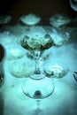 Glasses of champagne with a haze of dry ice with blue light at a party, alcoholic drink Royalty Free Stock Photo