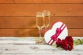 Glasses of champagne, heart shape gift box  and red roses. Concept of Valentine Day Royalty Free Stock Photo