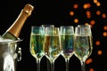 Glasses of champagne and ice bucket with bottle on background Royalty Free Stock Photo