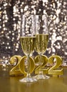 Two glasses of champagne at New Year`s Eve party 2022 golden shiny background stock images Royalty Free Stock Photo