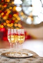 Glasses of champagne with rasberry on thepresent by the Christmas tree on background Royalty Free Stock Photo