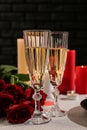 Glasses of champagne with red roses on festive table. Valentines Day celebration Royalty Free Stock Photo