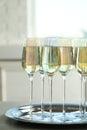 Glasses of champagne served on grey table