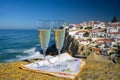 Glasses of champagne sparkling wine and view on white houses of picturesque village Azenhas do mar, Lisbon area, Portugal Royalty Free Stock Photo