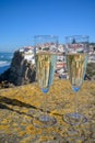 Glasses of champagne sparkling wine and view on white houses of picturesque village Azenhas do mar, Lisbon area, Portugal Royalty Free Stock Photo
