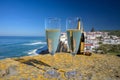 Glasses of champagne sparkling wine and view on white houses of picturesque village Azenhas do mar, Lisbon area, Portugal Royalty Free Stock Photo