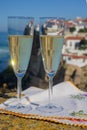 Glasses of champagne sparkling wine and view on white houses of picturesque village Azenhas do mar, Lisbon area, Portugal Royalty Free Stock Photo