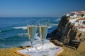 Glasses of champagne sparkling wine and view on white houses of picturesque village Azenhas do mar, Lisbon area, Portugal Royalty Free Stock Photo