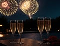 Glasses of champagne on a table with fireworks in the background