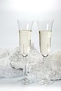 Glasses with champagne and wedding dress on a white background Royalty Free Stock Photo