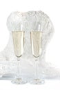 Glasses with champagne and wedding dress on a white background Royalty Free Stock Photo