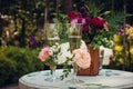 Champagne wine drink on a white wooden table decorated with white, pink and red flowers in a wooden brown vase Royalty Free Stock Photo