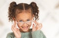 glasses, child face and eye care for vision in optometrist office. Excired young girl, happy and smile for eye exam