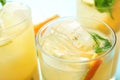 Glasses of citrus refreshing drink with ice cubes and mint,